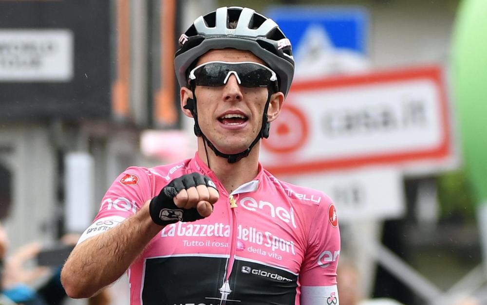 The overall leader wearing the pink jersey, British Simon Yates of the Mitchelton-Scott, celebrates as he crosses the finish line to win the 15th stage of the Giro d'Italia cycling race, over 176 km from Tolmezzo to Sappada, in Sappada, Italy, Sunday. — EPA