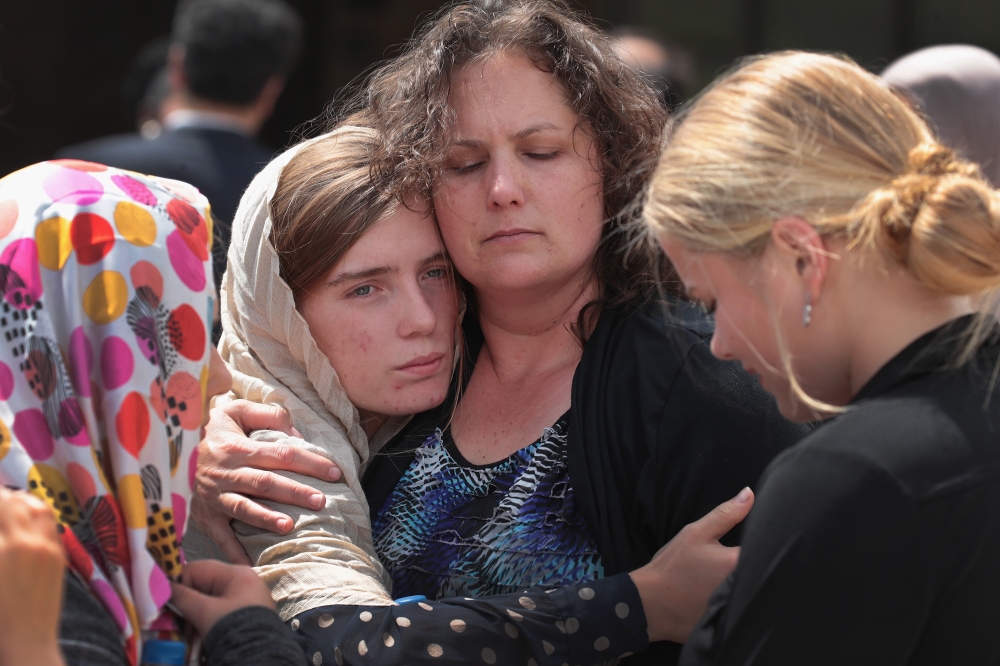 Host family members of Sabika Sheikh are comforted following a funeral prayer service at the Brand Lane Islamic Center in Stafford, Texas, on Sunday. — AFP