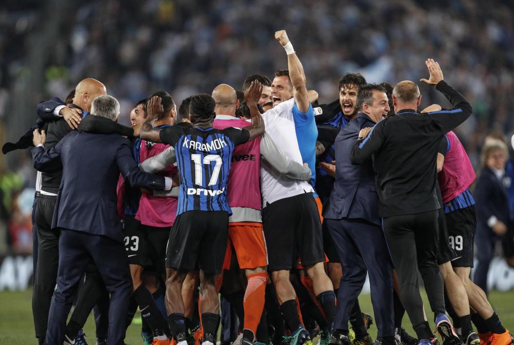 Inter Milan’s players celebrate after winning the Italian Serie A soccer match against Lazio at Olimpico Stadium in Rome Sunday. — EPA