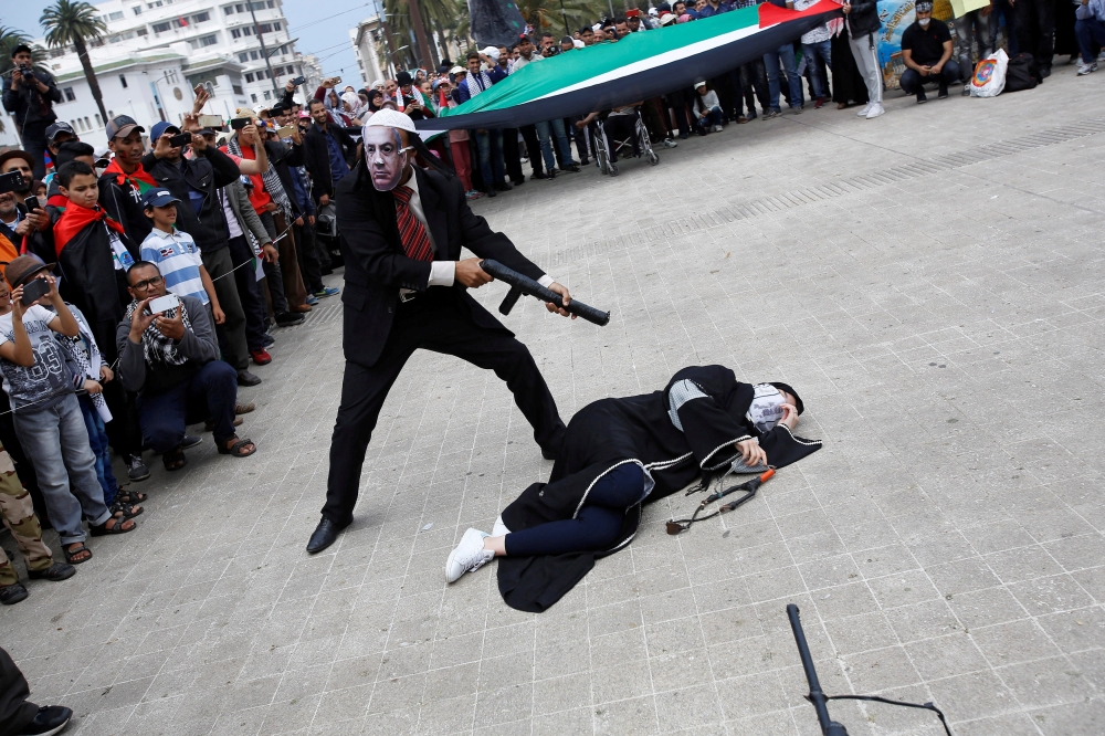 Pro-Palestinian protesters lie on the ground as they take part in a demonstration in solidarity with the Palestinian people, in Casablanca, Morocco. — Reuters