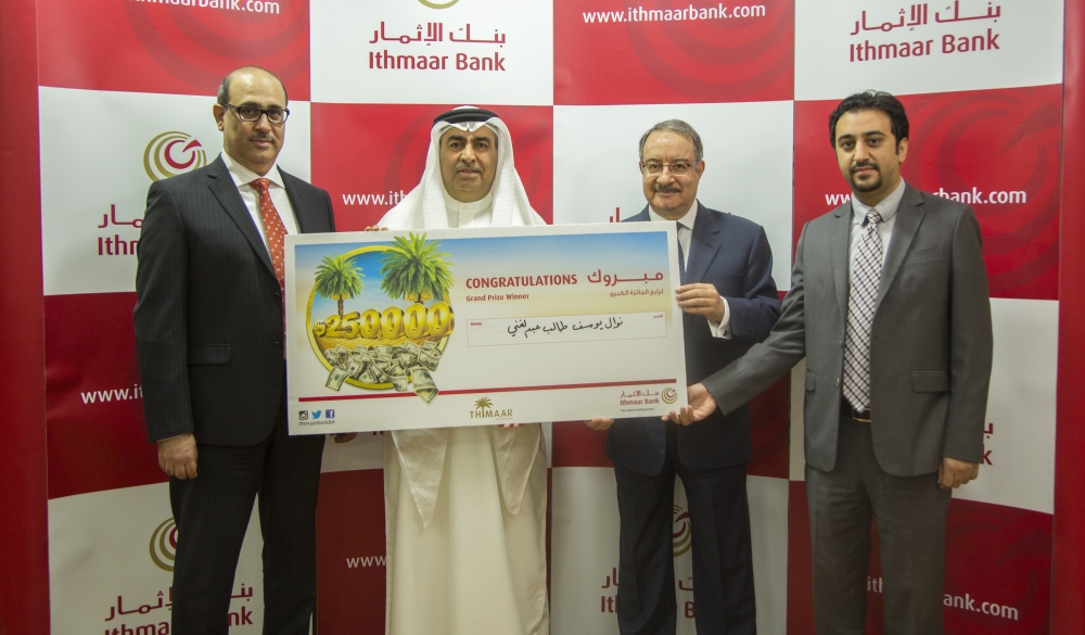Ithmaar Bank Chief Executive Officer Ahmed Abdul Rahim (second right) presents the prize to the winner’s husband Dr. Khaled Ali (second left) in presence of Ithmaar Bank Assistant General Manager, Head of Retail Banking, Mohammed Janahi (left) and Ithmaar Bank Marketing and Corporate Communications Manager, Mohamed Haji (right). — Courtesy photo