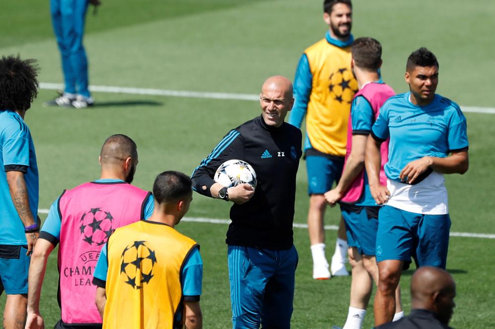 Real Madrid’s French head coach Zinedine Zidane (C) leads his team’s training session in Madrid. — EPA