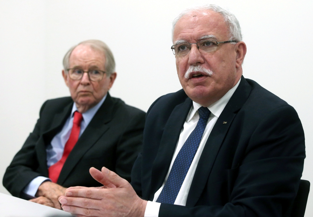 Palestinian Foreign Minister Riyad Al-Maliki holds a news conference next to legal adviser John Dugard at the International Criminal Court in The Hague, Netherlands, Tuesday. — Reuters