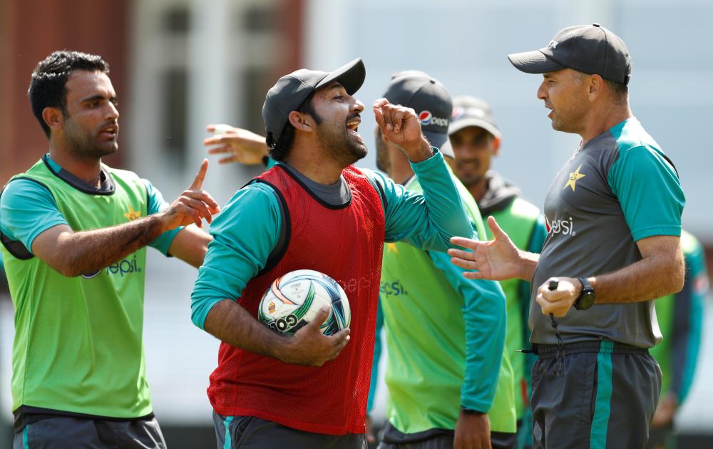 Pakistan skipper Sarfraz Ahmed argues with coach Mickey Arthur during football practice ahead of their Test match against England at Lord’s Cricket Ground in London Tuesday. — Reuters