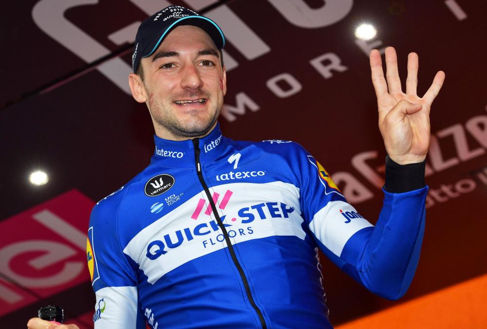 Italian rider Elia Viviani of the Quick-Step Floors team celebrates on the podium after winning the 17th stage of the Giro d'Italia cycling race over 155km from Riva del Garda to Iseo, Italy, Wednesday. — EPA