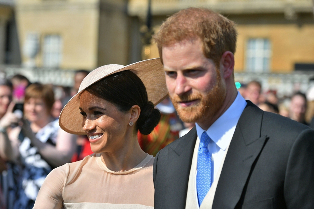 Britain's Prince Harry, Duke of Sussex, and his wife, Britain's Meghan, Duchess of Sussex, attend the Prince of Wales's 70th Birthday Garden Party at Buckingham Palace in London on Wednesday. - AFP