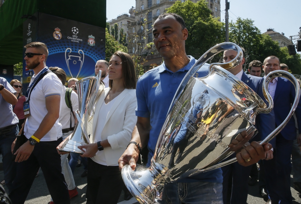 Iya Andrushchak (C), Ukrainian national soccer player and ambassador for the UEFA Women's Champions League final, and Cafu (R), the soccer star and former player of Milan carry the UEFA Champions League trophies during the opening ceremony of a Champions Festival in central Kiev, Ukraine, on Thursday. Real Madrid will face Liverpool FC in the UEFA Champions League final at the NSC Olimpiyskiy stadium in Kiev on Saturday.  — EPA