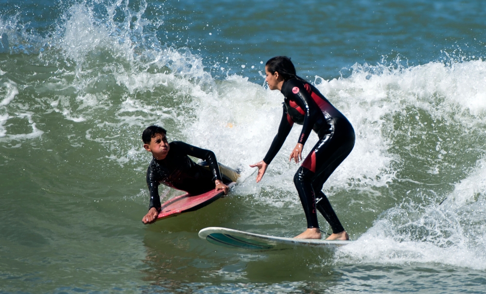 Meriem, a 29-year-old Moroccan engineer and surfer, surfs off the coast of Rabat. At Rabat's popular Udayas beach, women surfers prefer wearing traditional robes over stylish swimsuits, but they still face harassment out in the water.  — AFP 