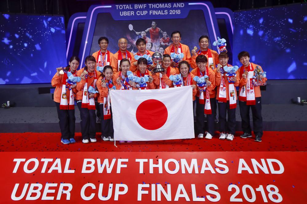 Team Japan poses on the podium with the Uber Cup after beating Thailand at the Thomas and Uber Cup 2018 in Bangkok Saturday. —  EPA