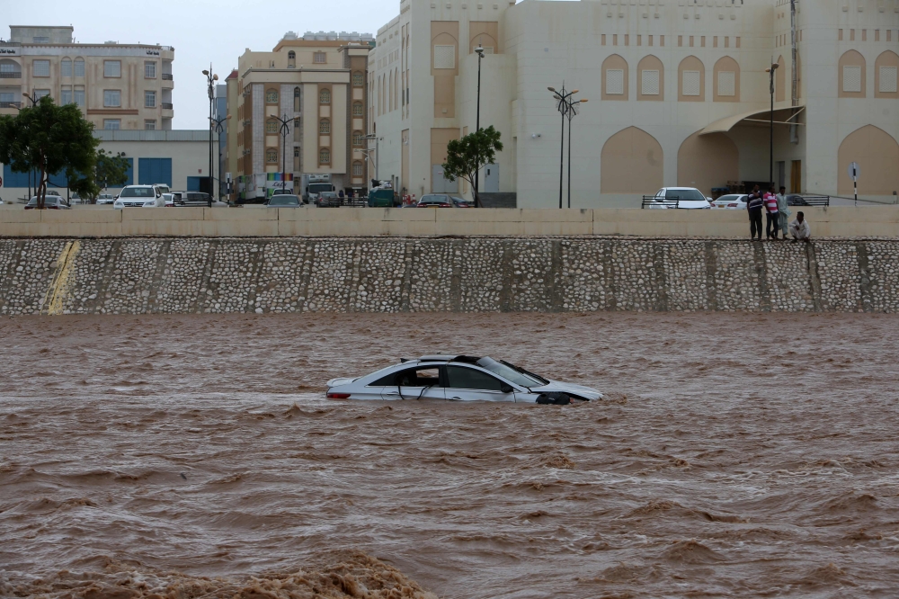 A car stuck in a flooded street in Salalah as Oman is hit by Cyclone Mekunu. Cyclone Mekunu was downgraded further to a deep depression Saturday, a day after lashing the southern coast of Oman and killing at least two people. — AFP