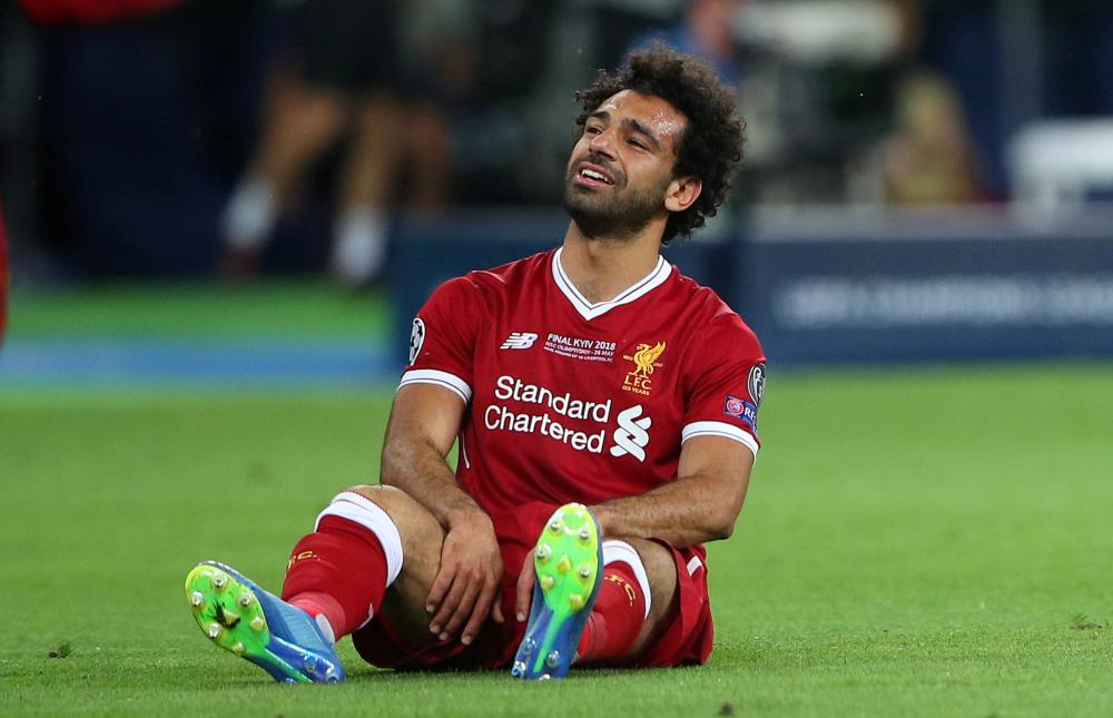 Liverpool's Mohamed Salah looks dejected after sustaining an injury during their Champions League final against Real Madrid in Kiev Saturday. — Reuters