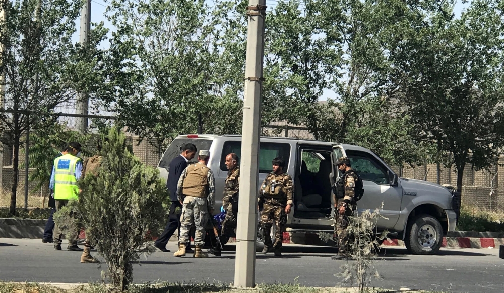 Afghan security officials inspect an armored vehicle used by the militants during attack on the Interior Ministry building in Kabul, Afghanistan, on Wednesday. — EPA