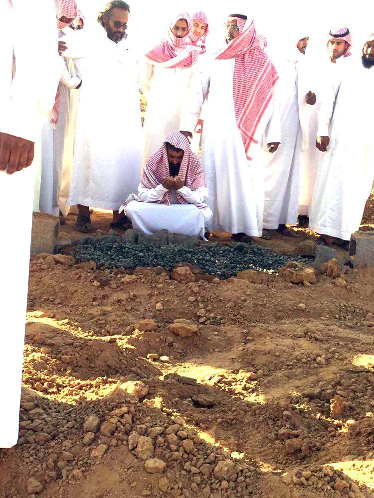 Ayadha Musaed Al-Enizi grieves at the grave of one of his daughters who died in Wednesday's house fire in Tabuk.