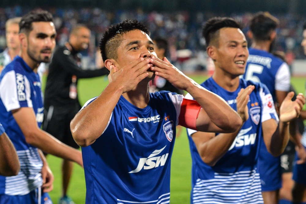 In this file photo, Indian club Bengaluru FC player Sunil Chhetri acknowledges the crowds after the team's 3-1 win against Pune City in the Hero ISL semifinals match at the Sree Kanteerava Stadium in Bangalore. Virat Kohli has joined a plea by India's football captain for fans to fill empty stadiums after just 2,569 turned up to watch the national team play. Cricket captain Kohli and batting legend Sachin Tendulkar backed Sunil Chhetri's heartfelt plea that went viral on social media after India thrashed Taiwan 5-0 in a near-empty Mumbai stadium during the last week of May. — AFP