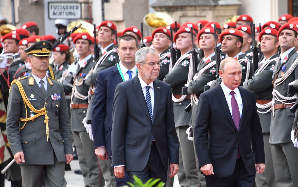 Austria’s President Alexander van der Bellen, center, and Russian President Vladimir Putin, right, inspect a military honor guard at the Presidential palace in Vienna, Austria, on Wednesday. — AFP