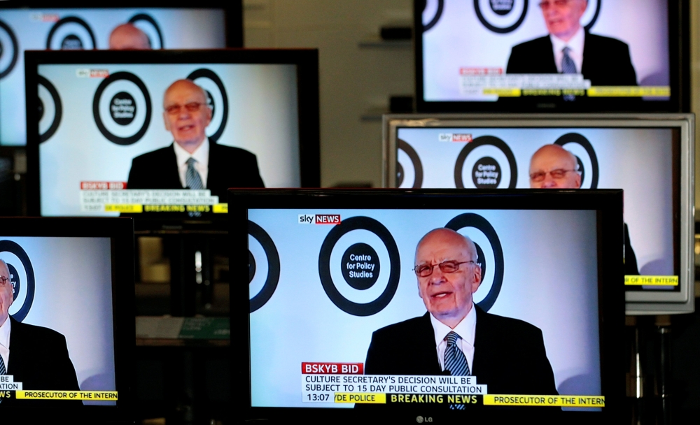 Chairman and chief executive of News Corporation Rupert Murdoch is seen talking on Sky News on television screens in an electrical store in Edinburgh, Britain, in this March 3, 2011 file photo. — Reuters