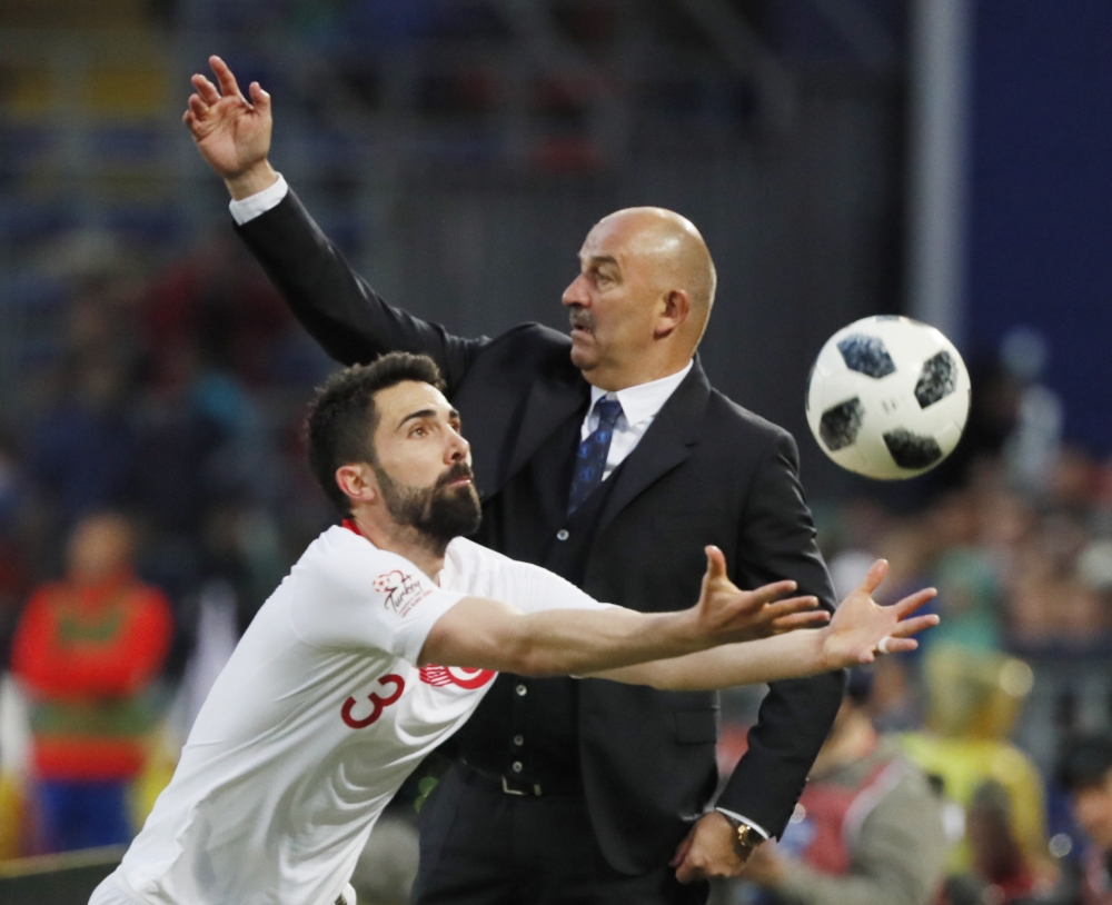 Russia's head coach Stanislav Cherchesov (R) reacts next to Hasan Ali Kaldirim of Turkey during the soccer friendly match between Russia and Turkey at VTB arena in Moscow, Russia, on Tuesday. — EPA