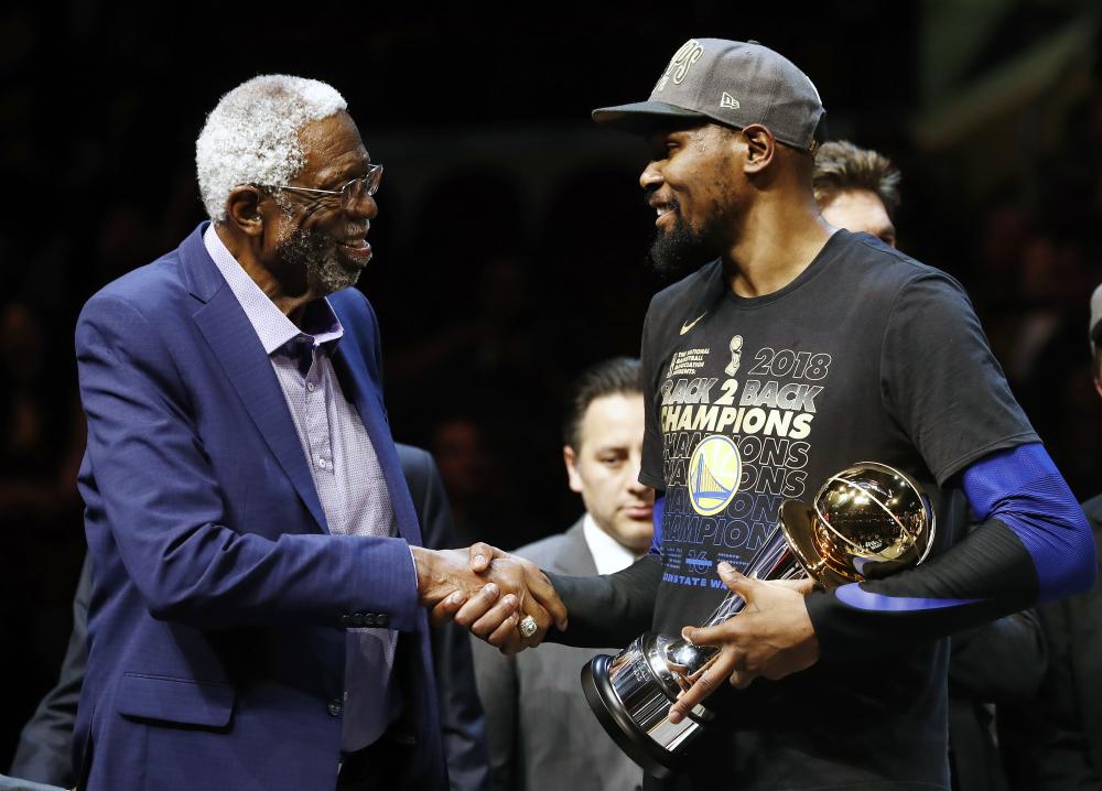 Kevin Durant (R) of the Golden State Warriors receives the MVP trophy from Bill Russell at Quicken Loans Arena in Cleveland Friday.  — EPA