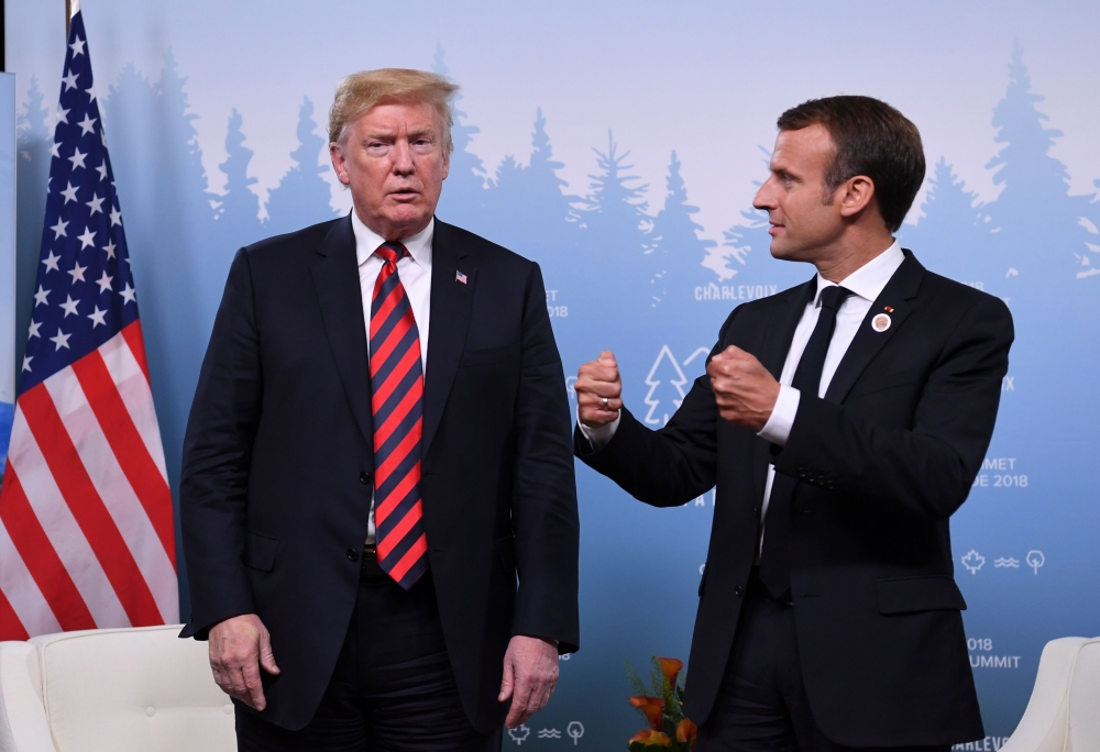US President Donald Trump and French President Emmanuel Macron hold a meeting on the sidelines of the G7 Summit in in La Malbaie, Quebec, on Friday. — AFP