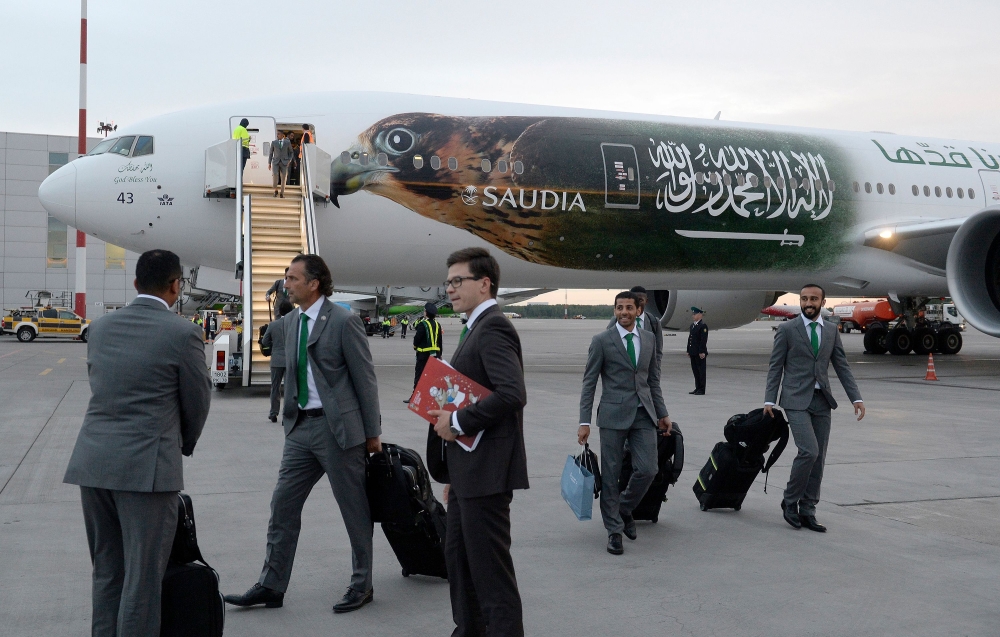 Saudi Arabia's national football team coach Juan Antonio Pizzi (2ndL) and his footballers arrive at Saint Petersburg's Pulkovo airport on Saturday, ahead of the 2018 FIFA World Cup football tournament in Russia. — AFP