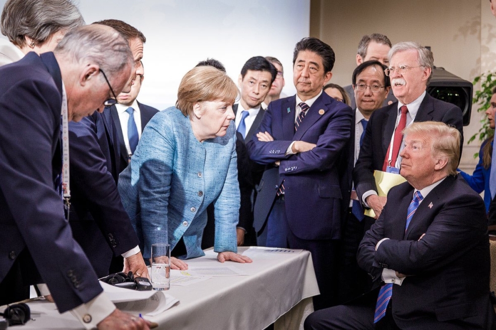 US President Donald Trump, right, talks with German Chancellor Angela Merkel, center,  and surrounded by other G7 leaders during a meeting of the G7 Summit in La Malbaie, Quebec, Canada, in this June 8, 2018 file photo. — AFP