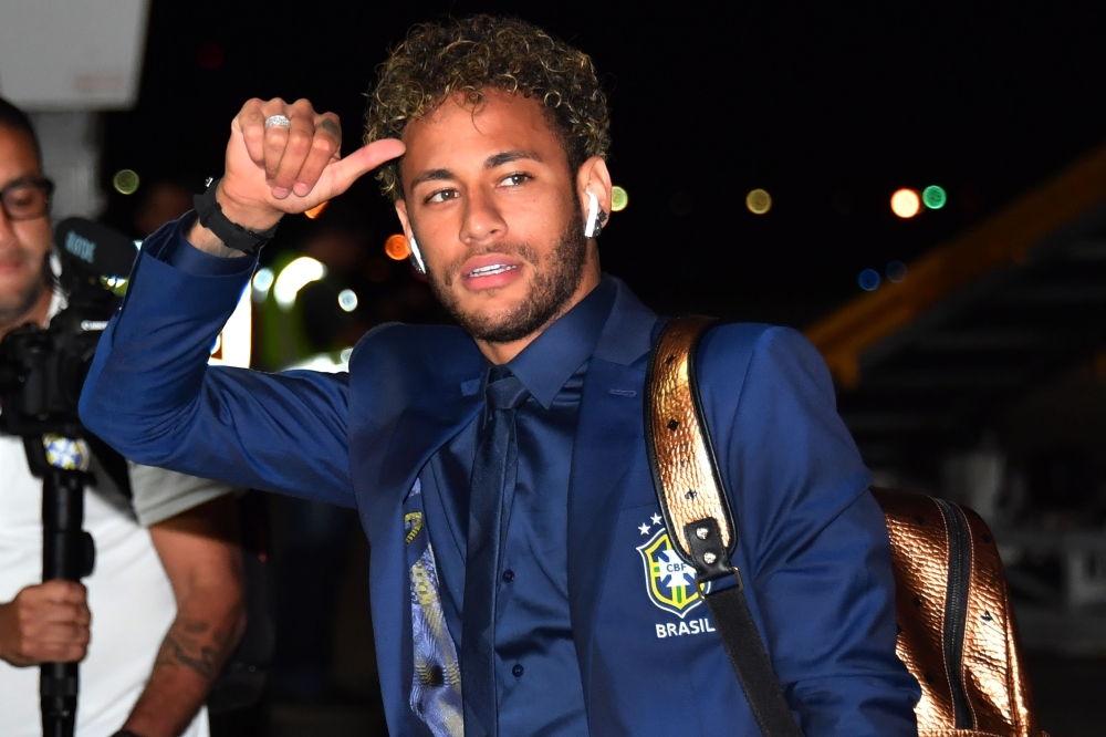 Brazil's forward Neymar gestures upon the team's landing at Sochi airport, in Russia on Monday, ahead of the FIFA World Cup. — AFP