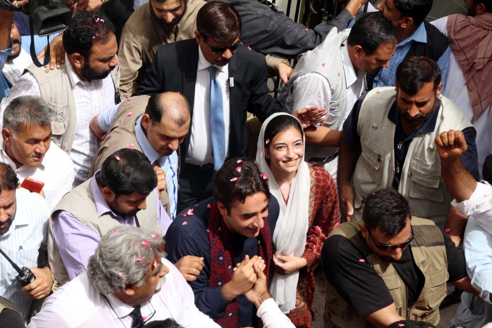Supporters of opposition political party Pakistan People Party gather around party’s chairman Bilawal Bhutto Zardari and his sister Asifa Bhutto Zardari, as he arrives to submit his nomination papers to contest for the general elections, in Larkana, Pakistan, on Monday. — EPA
