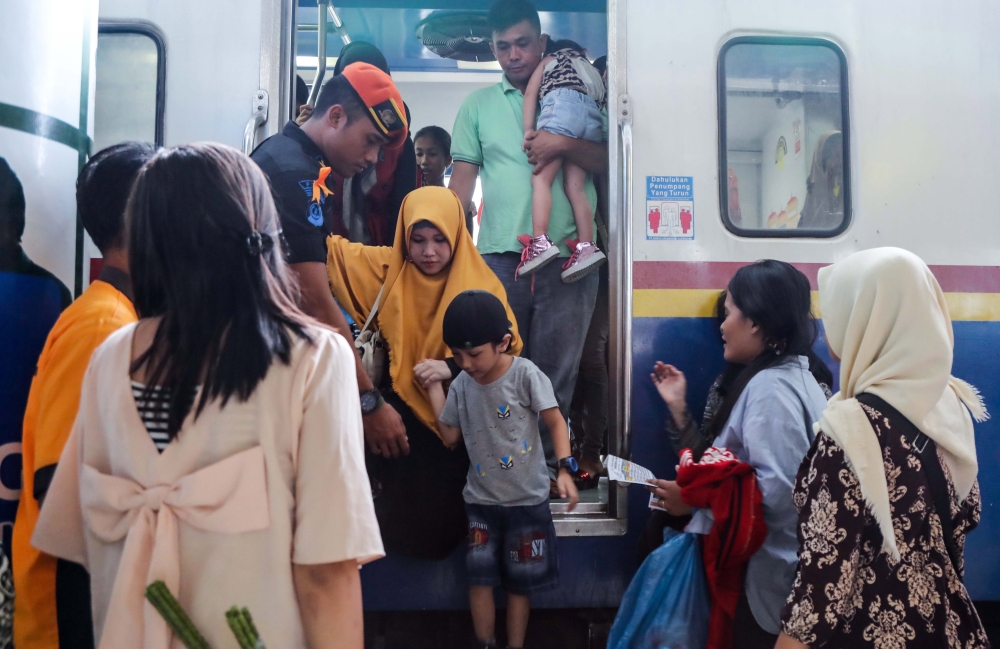 Indonesians wait to board a train to return to their home villages to celebrate Eid Al-Fitr, at the train station in Medan, North Sumatra, Indonesia, on Wednesday. — EPA