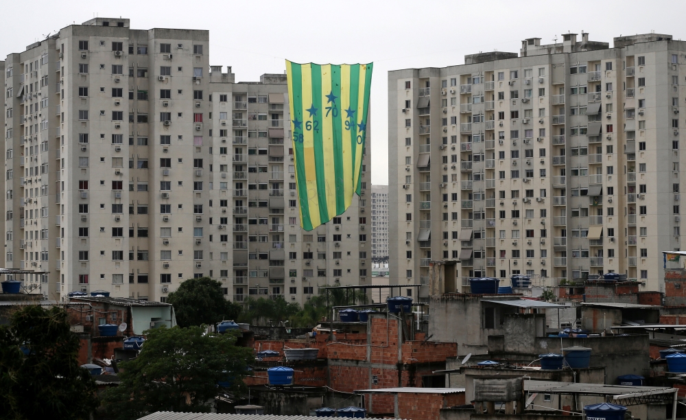 A flag with the Brazilian national colors is seen between two buildings to celebrate the FIFA World Cup in Rio de Janeiro, Brazil, on Friday. — Reuters