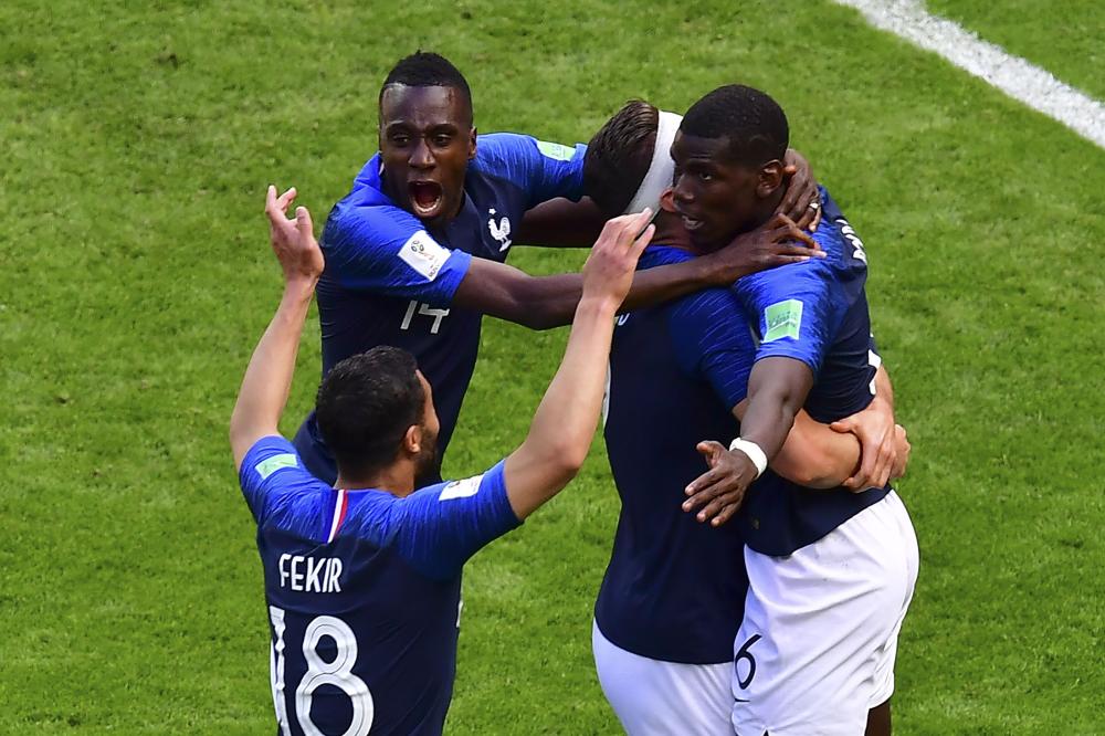 France's players hug midfielder Paul Pogba (R) to celebrate the winning goal against Australia during the Russia 2018 World Cup at the Kazan Arena in Kazan Saturday. — AFP