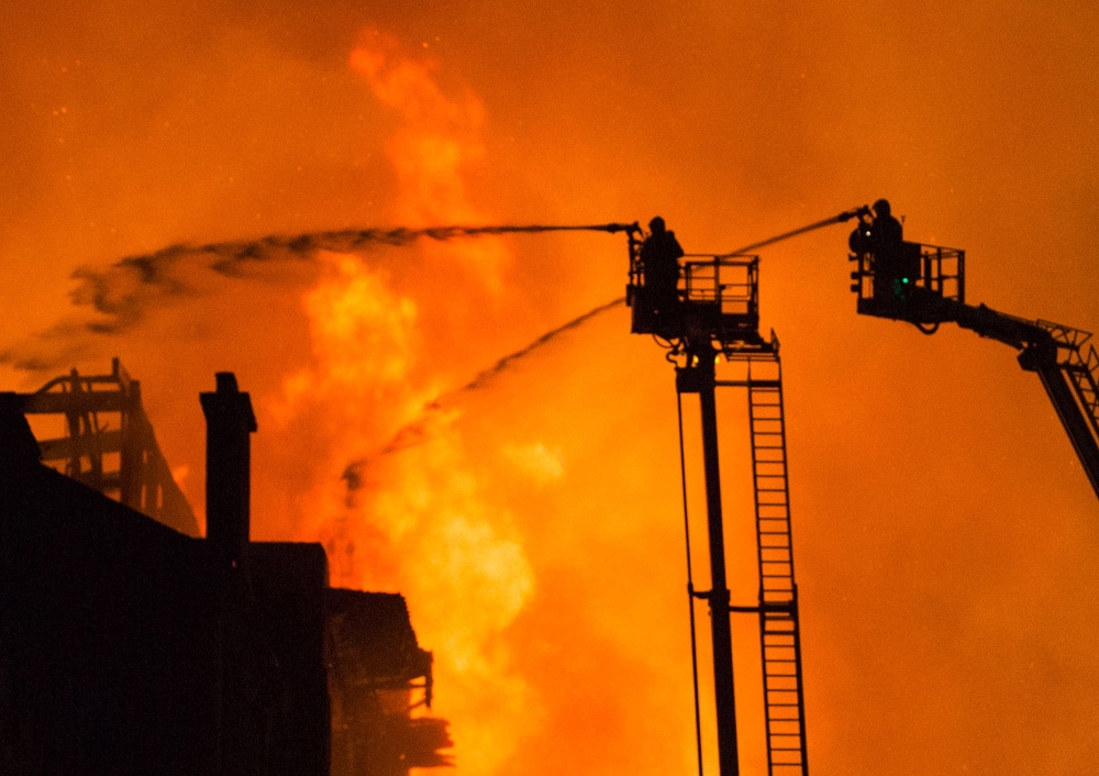 Firefighters battle with a fire blazing at the Mackintosh Building, housing the Glasgow School of Art, in Glasgow, Scotland, Britain, on Saturday. — EPA