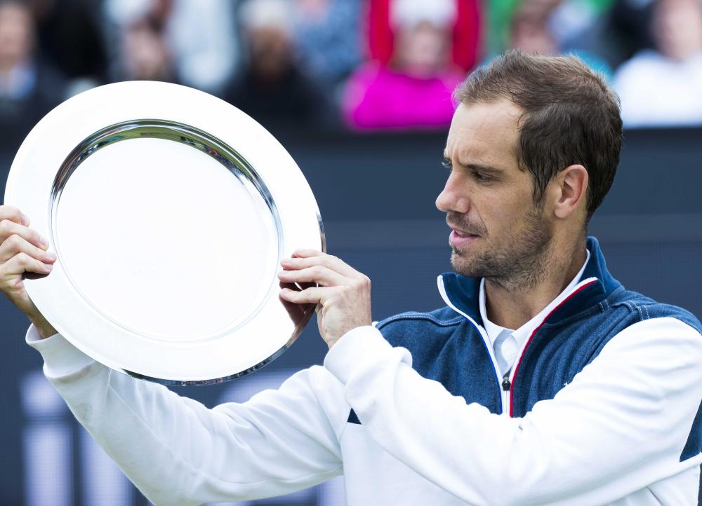 Richard Gasquet of France celebrates with the trophy after winning against French Jeremy Chardy in the final  of the Libema Open Tennis Tournament in Rosmalen, The Netherlands, Sunday.  — EPA 