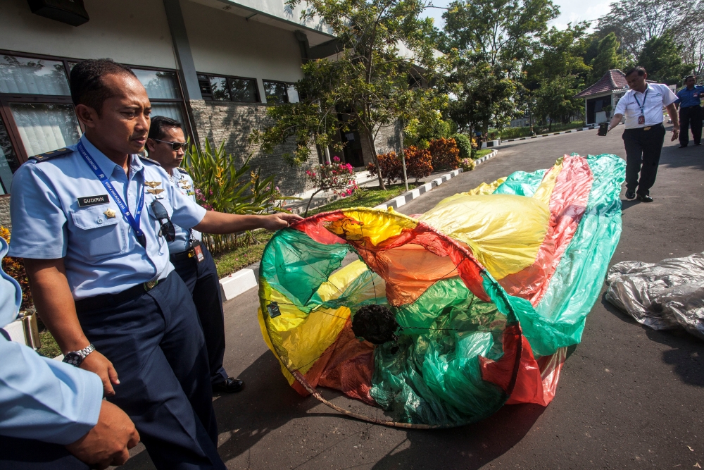 Officers show an unmanned hot air balloon, used in traditional festivities for celebrating Eid Al-Fitr, during a press conference at  AirNav Indonesia, in Yogyakarta , Indonesia, on Saturday. — Reuters