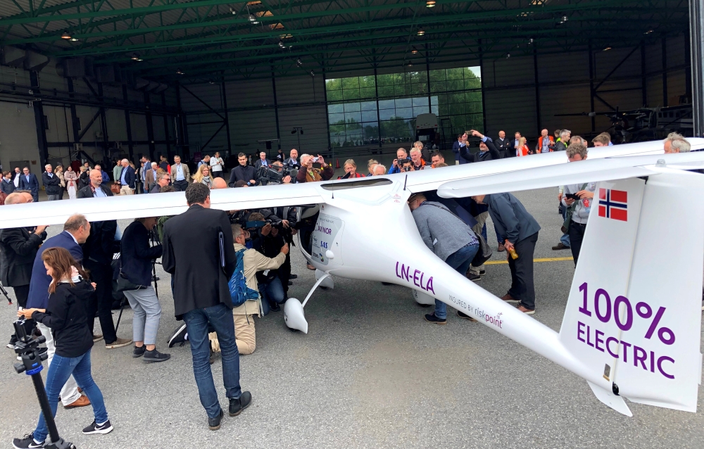 People stand around a two-seat electric plane made by Slovenian company Pipistrel after a test flight at Oslo Airport, Norway, on Monday. — Reuters