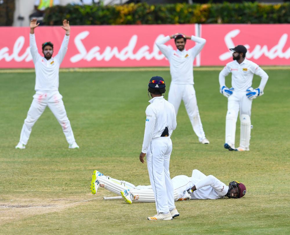 Jason Holder (on ground) of West Indies hurt by a delivery by Lahiru Kumara of Sri Lanka during their 2nd Test at Daren Sammy Cricket Ground, Gros Islet, St. Lucia, Monday. — AFP 