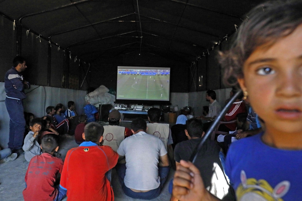 For these soccer enthusiasts uprooted by Syria's seven-year war, World Cup games such as these offer brief respite from their woes and the daily grind at the camp. — AFP