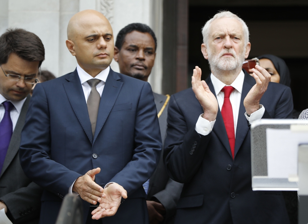 Britain’s Home Secretary Sajid Javid, left, and Jeremy Corbyn, opposition Labour party leader applaud on the steps of Islington Town Hall on the anniversary of the Finsbury park attack in London on Tuesday. — AFP