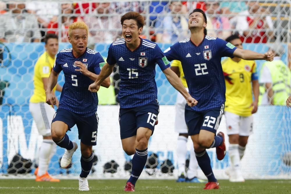 Japan's forward Yuya Osako (C) celebrates with teammates after scoring against Colombia during the Russia 2018 World Cup Group H match at the Mordovia Arena in Saransk Tuesday.  — AFP