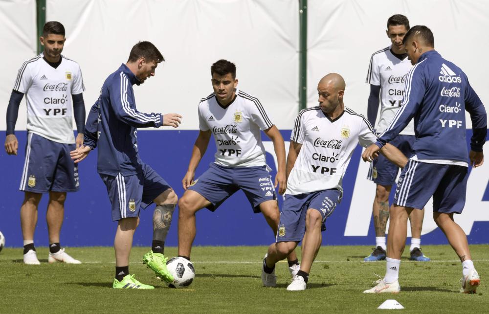 Argentina’s Lionel Messi (2nd L) vie with defender Marcos Acuna (C) and midfielder Javier Mascherano (2nd R) during training session at the team’s base camp in Bronnitsy, near Moscow, Wednesday. — AFP 