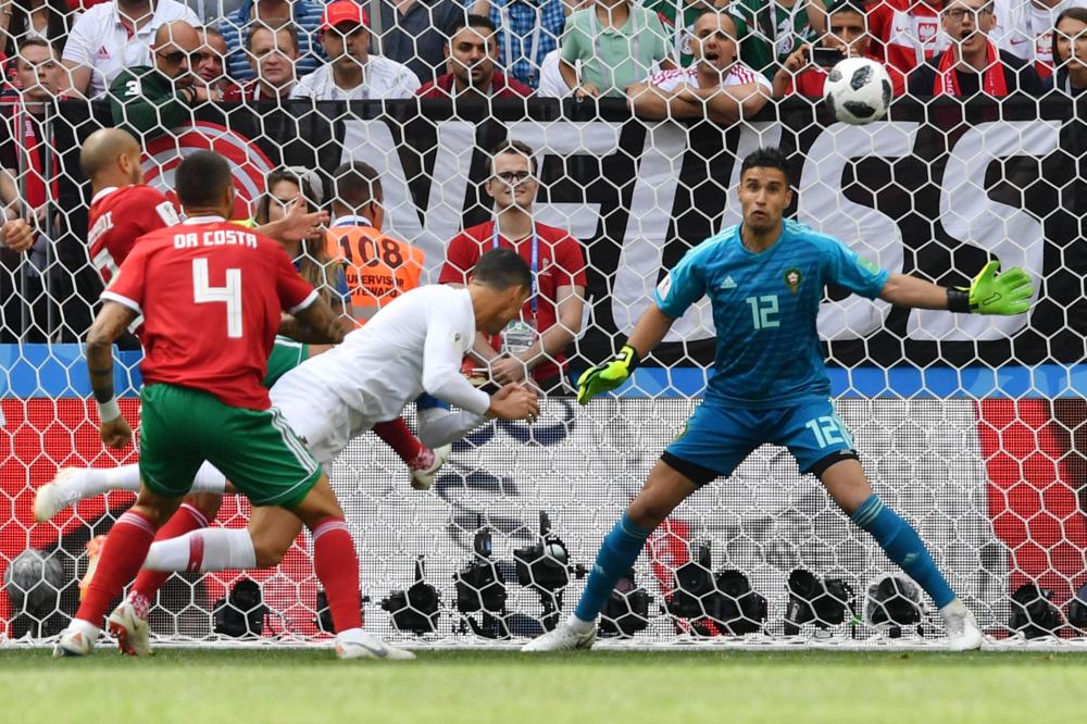 Portugal’s forward Cristiano Ronaldo scores off a header during the Russia 2018 World Cup Group B football match against Morocco at the Luzhniki Stadium in Moscow Wednesday. — AFP 