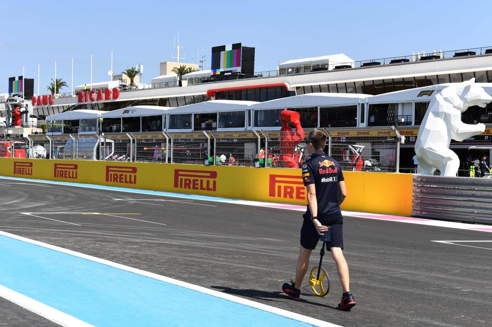 A Red Bull technician measures the start position on the Circuit Paul Ricard in Le Castellet, southern France, Thursday. — AFP 