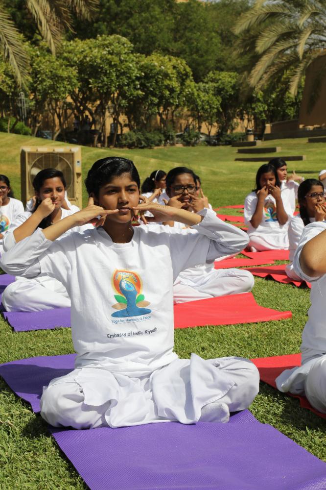 Indian Ambassador Ahmad Javed is seen demonstrating a yoga posture. 