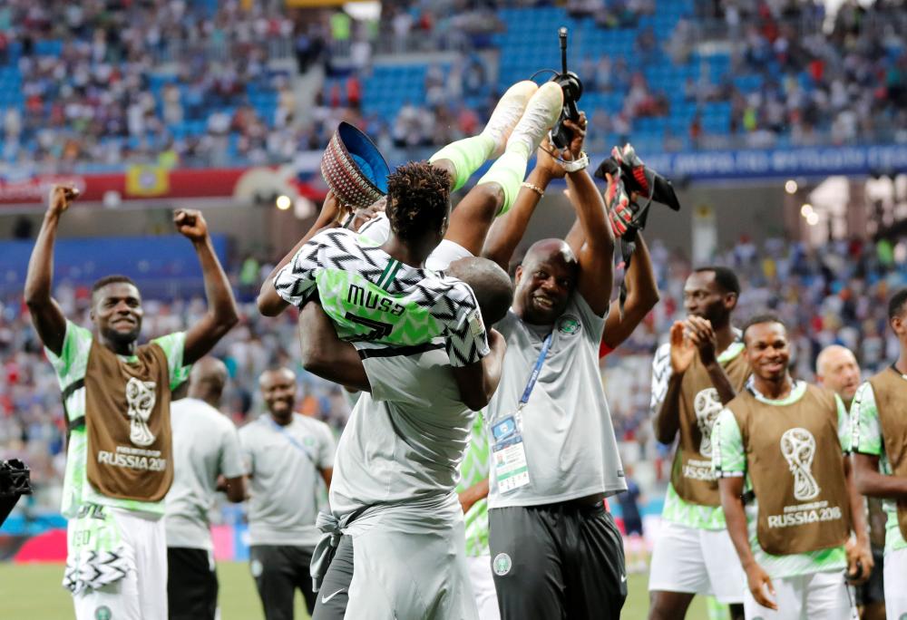 Nigeria's Ahmed Musa being carried by teammates while celebrating their victory over Iceland in their World Cup match at Volgograd Arena in Russia Friday. — Reuters