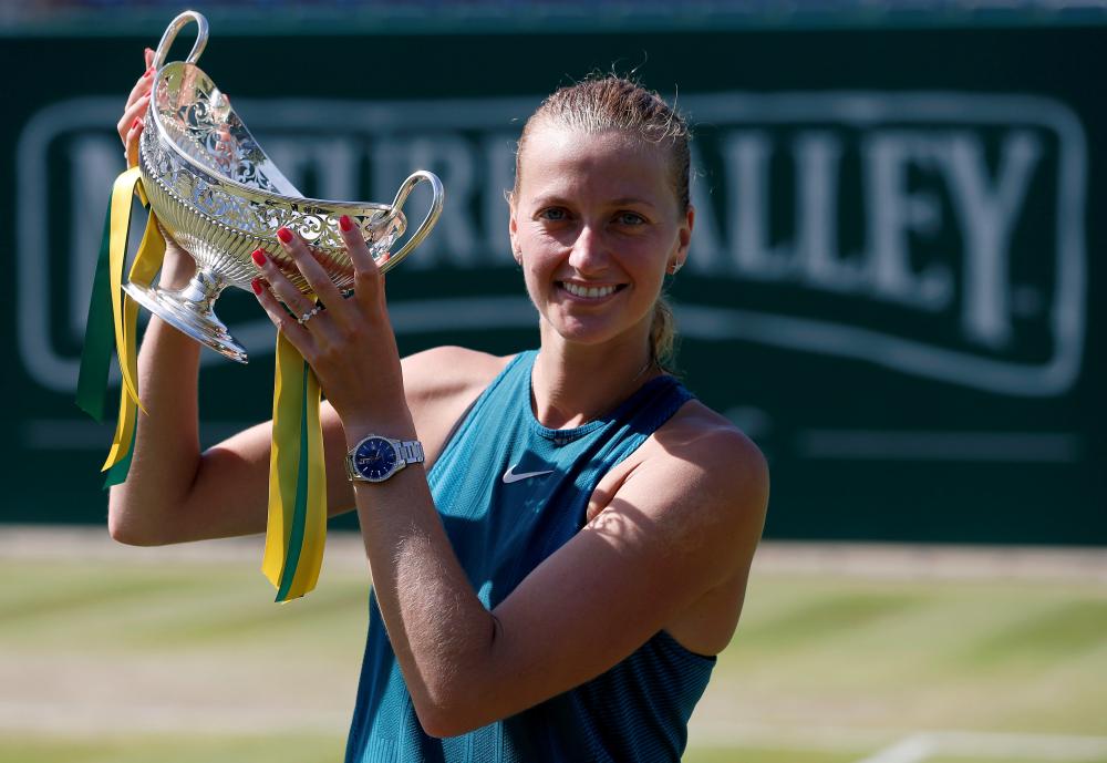 Czech Republic’s Petra Kvitova celebrates with the Maud Watson Trophy after winning the final against Slovakia’s Magdalena Rybarikova at the Birmingham Tennis Tournament Sunday. — Reuters