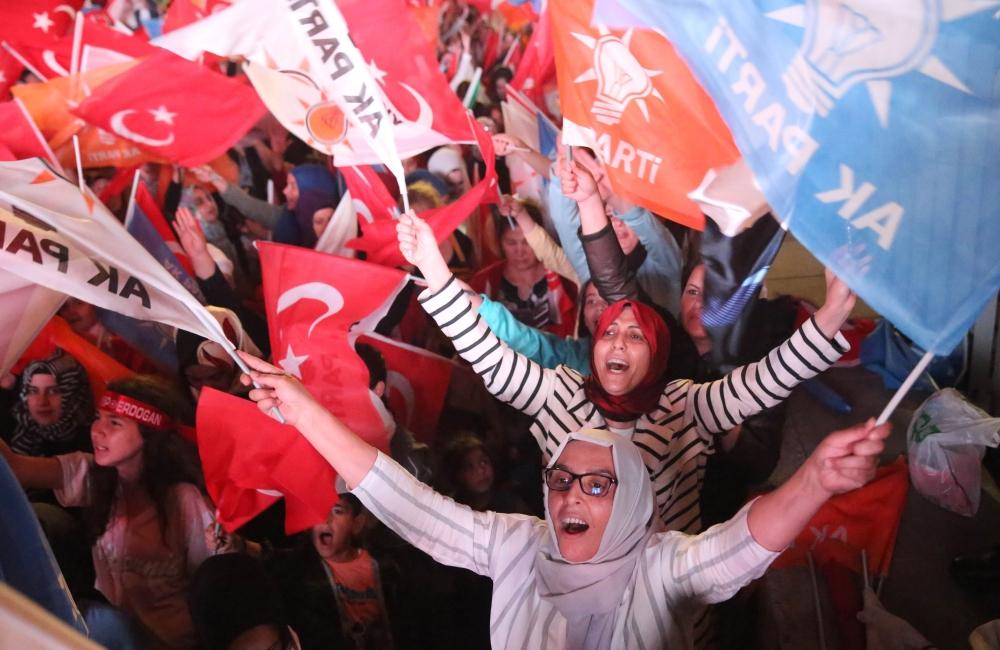 Turkish President Recep Tayyip Erdogan (C) speaks to suppporters in Istanbul on Sunday. — AFP