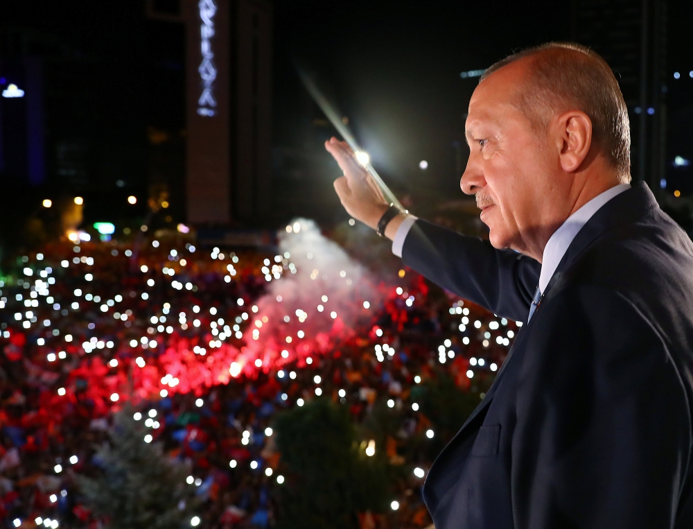 Turkish President Tayyip Erdogan greets his supporters from the balcony of his ruling AK Party headquarters in Ankara, Turkey, early Monday. — Reuters