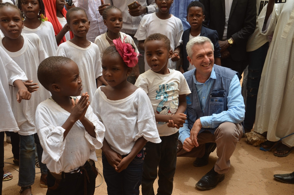 United Nations High Commissioner for Refugees Filippo Grandi poses with a group of refugee children in Agadez. Grandi urged European countries to speed up the procedures for leaving transit countries refugees who have decided to host on their soil. — AFP photos