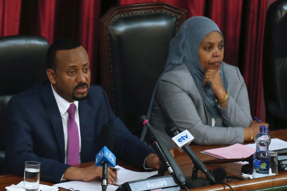 Ethiopia's newly elected Prime Minister Abiy Ahmed (L), flanked by parliament speaker, Muferiat Kamil, addresses the members of parliament inside the House of Peoples' Representatives, during a meeting for the approval of 2018/19 budget in Addis Ababa, Ethiopia, on Friday. — Reuters