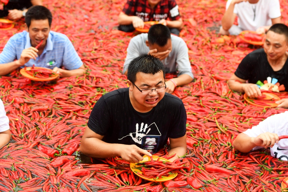 Contestants take part in a chili pepper-eating competition in Ningxiang, in China's central Hunan province, on Monday. - AFP