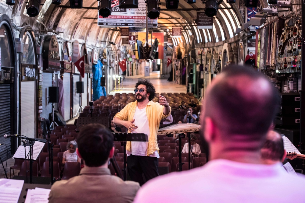 Turkish traditional musician and conductor Hakan Gungor performs during a rehearsal ahead of the 46th edition of the Istanbul Music Festival at the Grand Bazaar in Istanbul, Turkey. - AFP